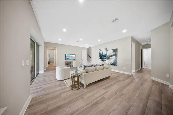 a dining room with furniture a chandelier and window