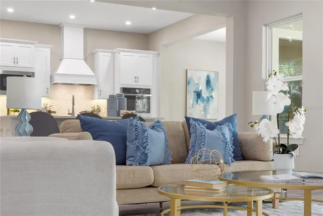 a view of a dining room with furniture and chandelier