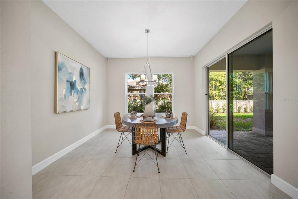 10199 Brocksport Circle Gotha, FL 34734 - Photo 26 of 82 a dining room with furniture a chandelier and window