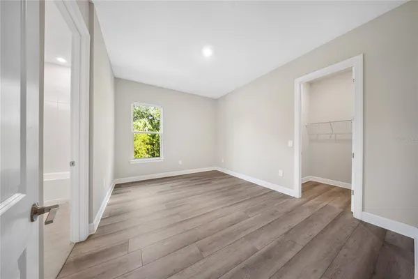 a bathroom with a double vanity sink toilet mirror and shower