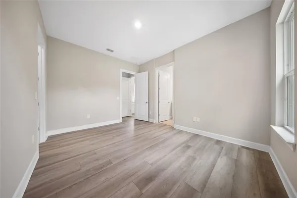 a spacious bathroom with a double vanity sink a mirror and a bathtub