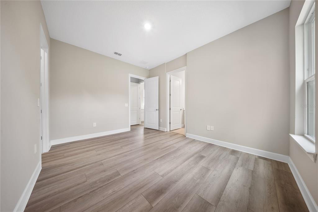 10199 Brocksport Circle Gotha, FL 34734 - Photo 31 of 82 a view of an empty room with wooden floor and a window