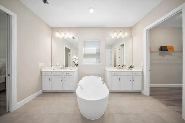 a view of swimming pool with seating area and trees in the background
