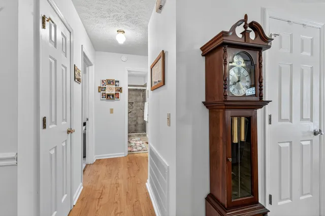 a view of hallway with wooden floor and stairs