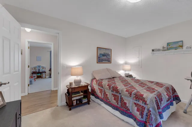 a bedroom with a bed and a lamp