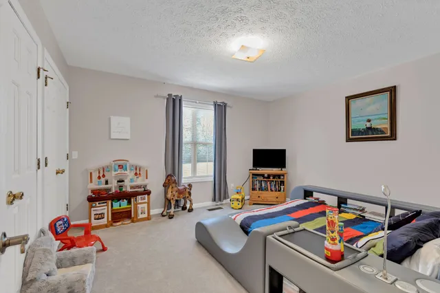 a bedroom with furniture and a window