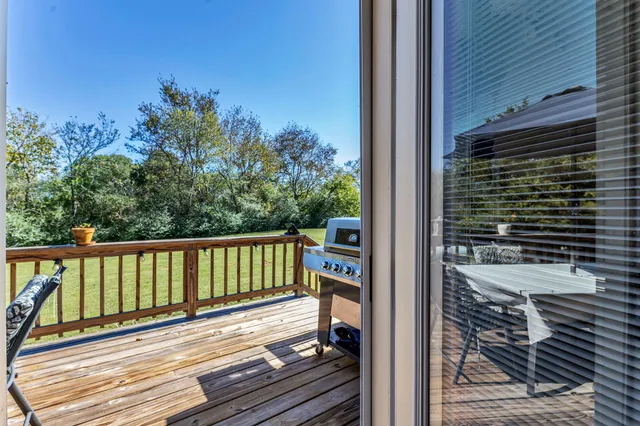 a view of a balcony with wooden floor and fence