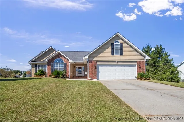 a front view of a house with a yard and garage