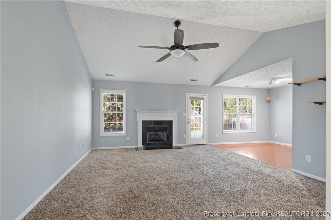 103 Beaumont Court Raeford, NC 28376 - Photo 11 of 50 a view of empty room with fireplace and windows