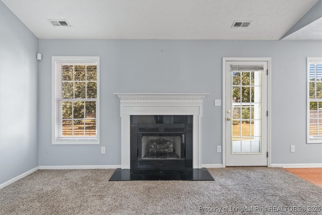 103 Beaumont Court Raeford, NC 28376 - Photo 12 of 50 a living room with a fireplace and a window