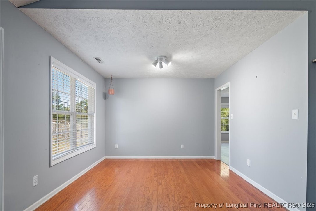103 Beaumont Court Raeford, NC 28376 - Photo 18 of 50 a view of an empty room with wooden floor and a window