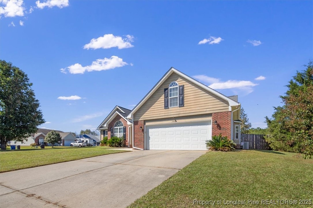 103 Beaumont Court Raeford, NC 28376 - Photo 2 of 50 a front view of a house with a yard and garage