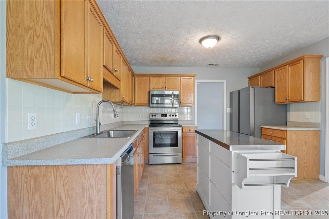 103 Beaumont Court Raeford, NC 28376 - Photo 24 of 50 a kitchen with stainless steel appliances granite countertop a sink and a stove