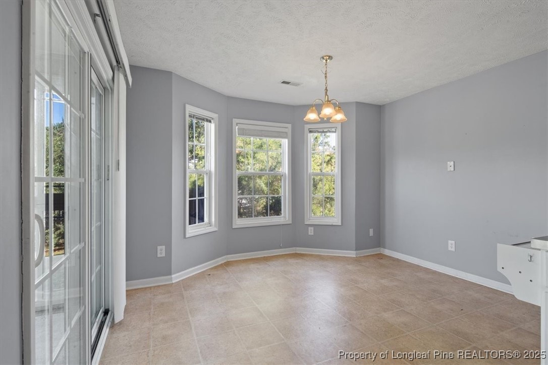 103 Beaumont Court Raeford, NC 28376 - Photo 28 of 50 a view of a room with windows and chandelier