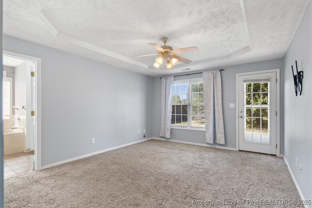 103 Beaumont Court Raeford, NC 28376 - Photo 29 of 50 an empty room with chandelier fan and windows