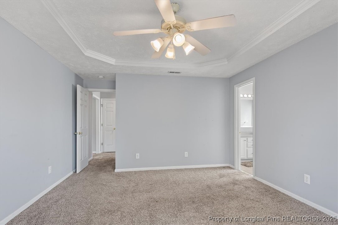 103 Beaumont Court Raeford, NC 28376 - Photo 30 of 50 an empty room with a chandelier fan and windows