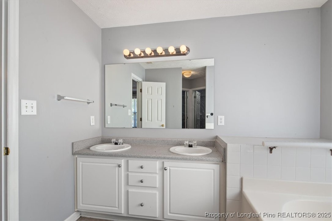 103 Beaumont Court Raeford, NC 28376 - Photo 32 of 50 a bathroom with a sink and a mirror