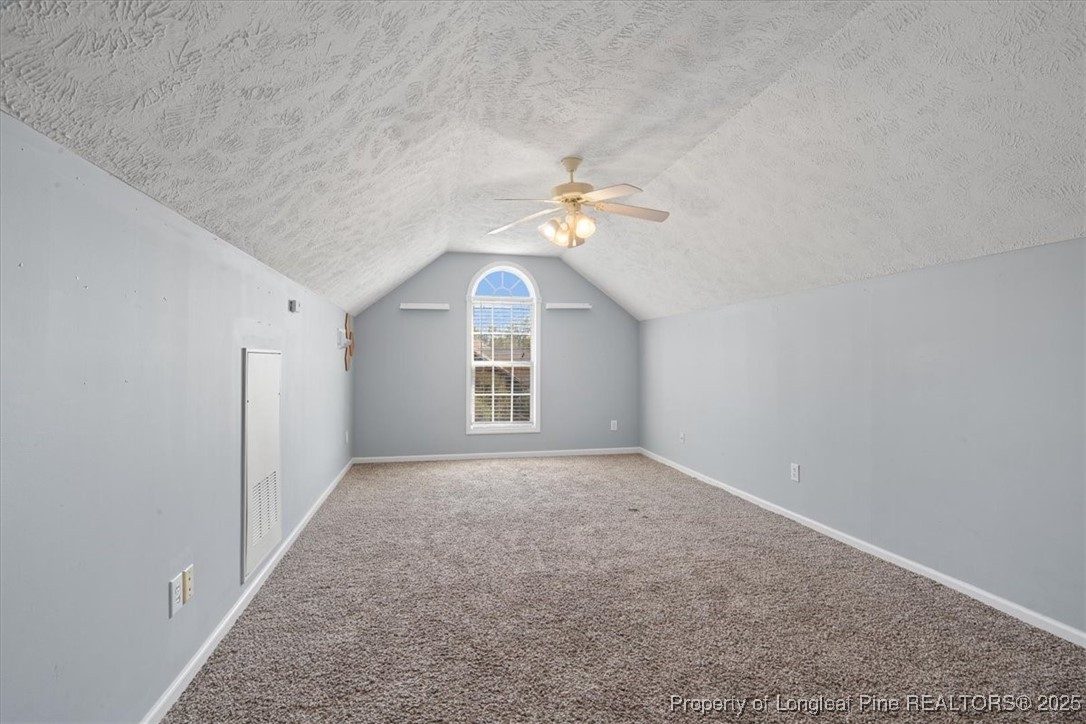 103 Beaumont Court Raeford, NC 28376 - Photo 43 of 50 an empty room with a chandelier fan and windows