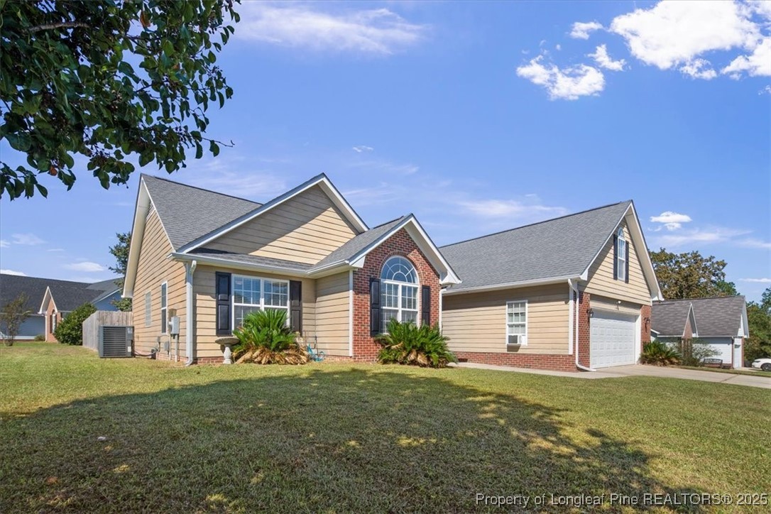103 Beaumont Court Raeford, NC 28376 - Photo 5 of 50 a front view of a house with a garden