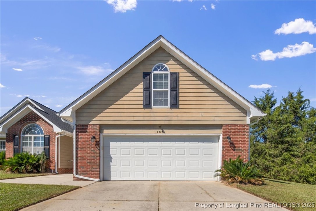 103 Beaumont Court Raeford, NC 28376 - Photo 6 of 50 a front view of a house with a yard and garage