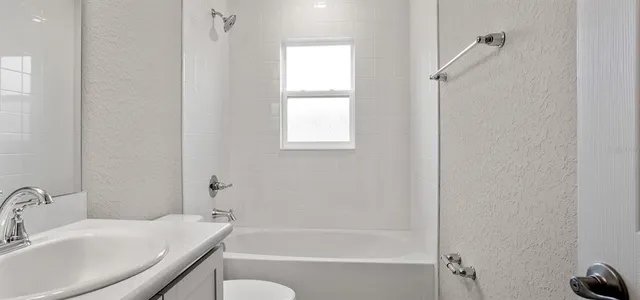 a white bath tub sitting next to a white sink
