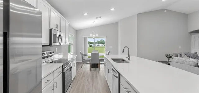 a kitchen with counter top space a sink stove and refrigerator