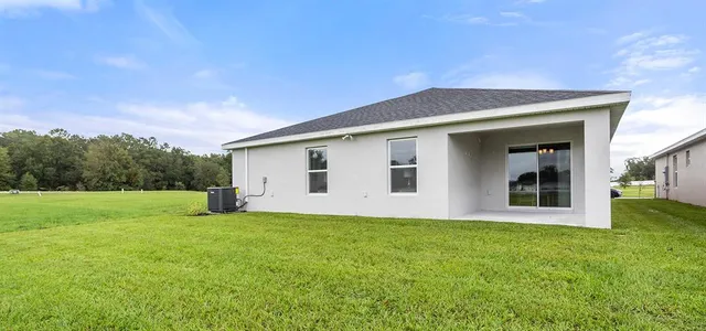 a big house with a big yard and large trees