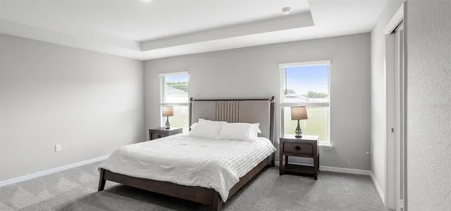 a bedroom with a bed and a night stand