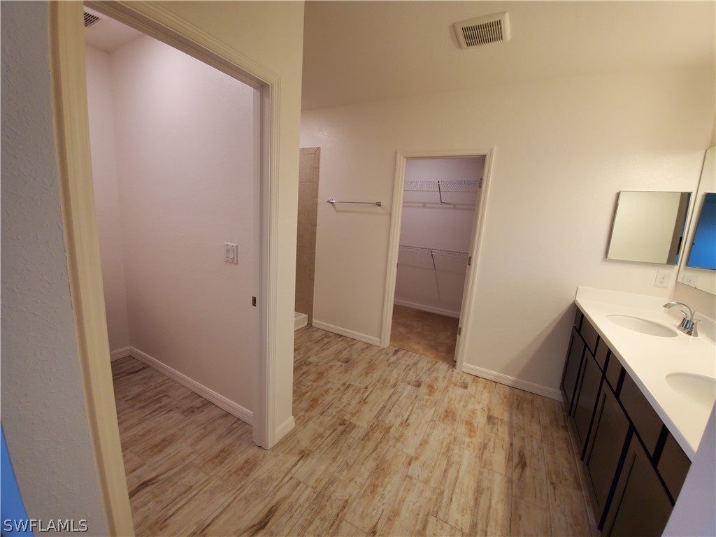 3916 Sunset Road Lehigh Acres, FL 33971 - Photo 5 of 11 a view of hallway with wooden floor