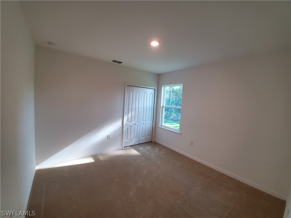 3916 Sunset Road Lehigh Acres, FL 33971 - Photo 7 of 11 a view of an empty room with a window