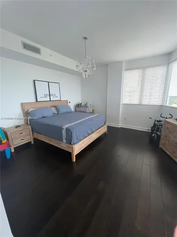 a bed sitting in a room next to a window