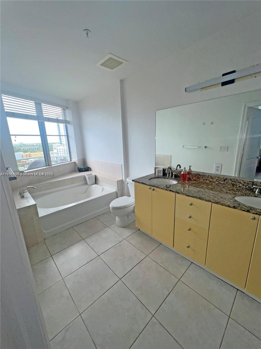 1830 Radius Drive, Unit 1123 Hollywood, FL 33020 - Photo 16 of 26 a kitchen with a sink and cabinets