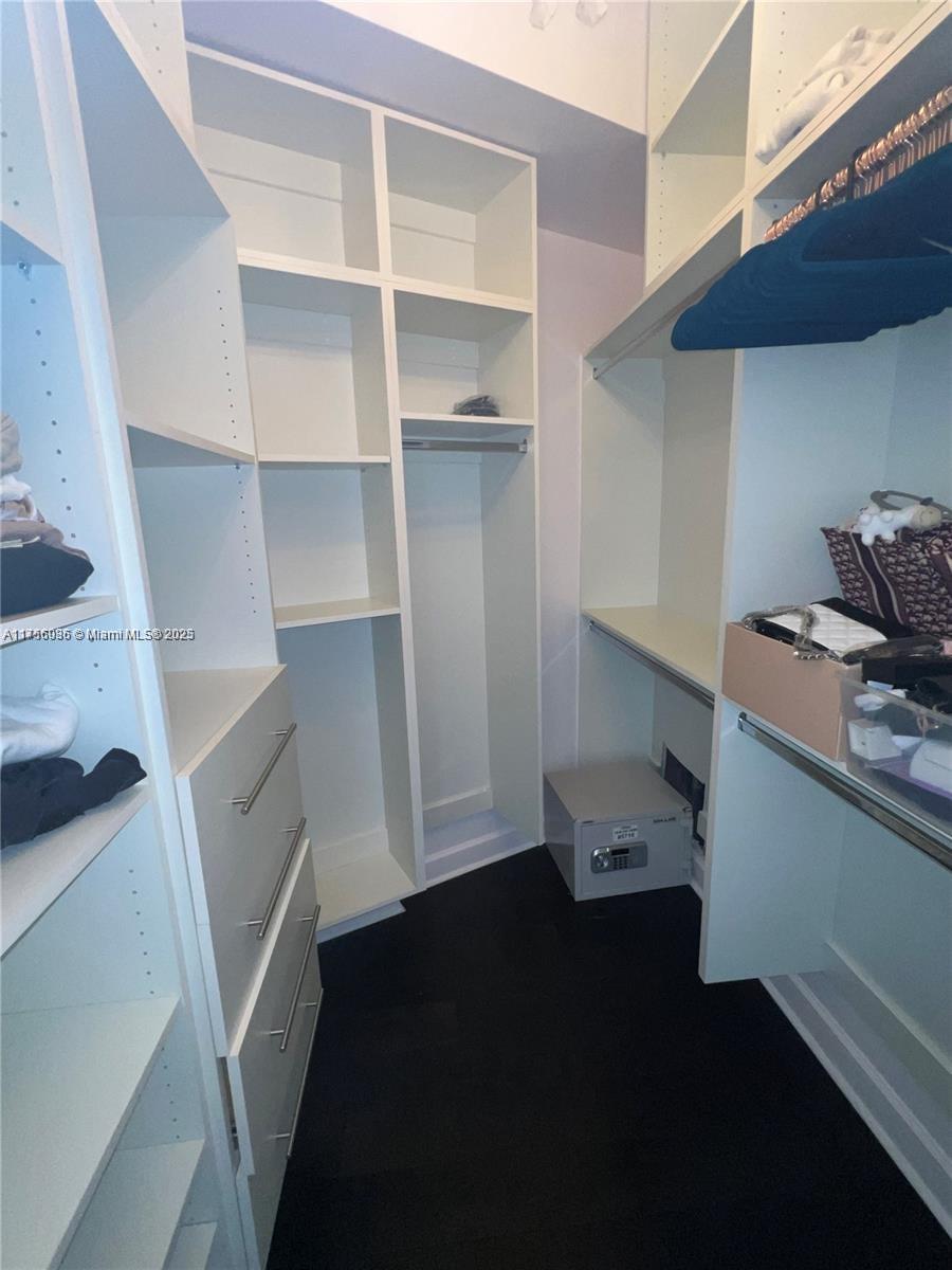 1830 Radius Drive, Unit 1123 Hollywood, FL 33020 - Photo 20 of 26 a walk in closet with wooden floor