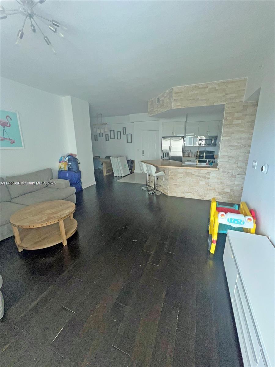 1830 Radius Drive, Unit 1123 Hollywood, FL 33020 - Photo 9 of 26 a living room with furniture and a table