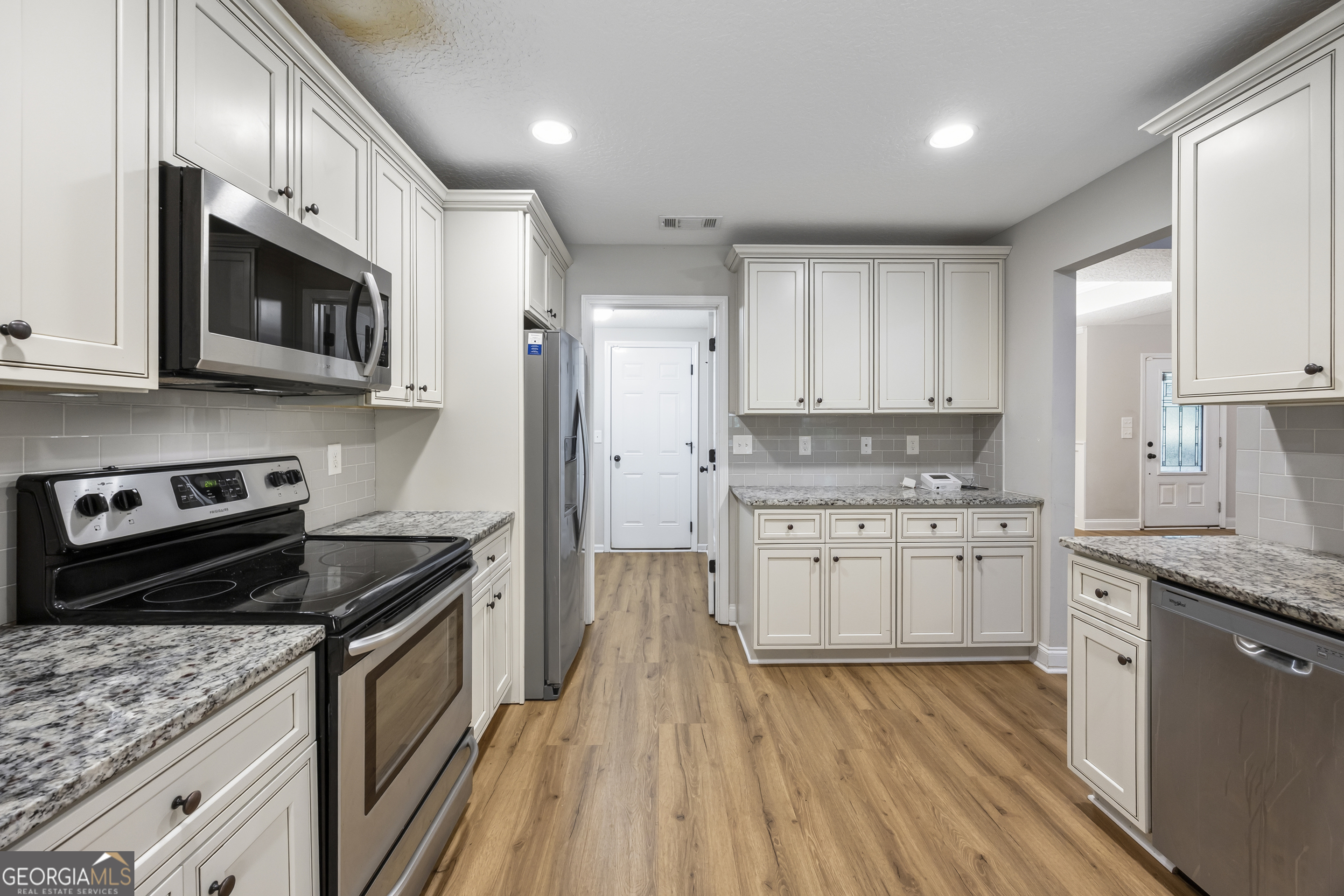 717 Oconee Lane Commerce, GA 30529 - Photo 27 of 57 a kitchen with granite countertop cabinets stainless steel appliances and a counter space