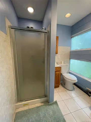 a bathroom with a toilet and a shower