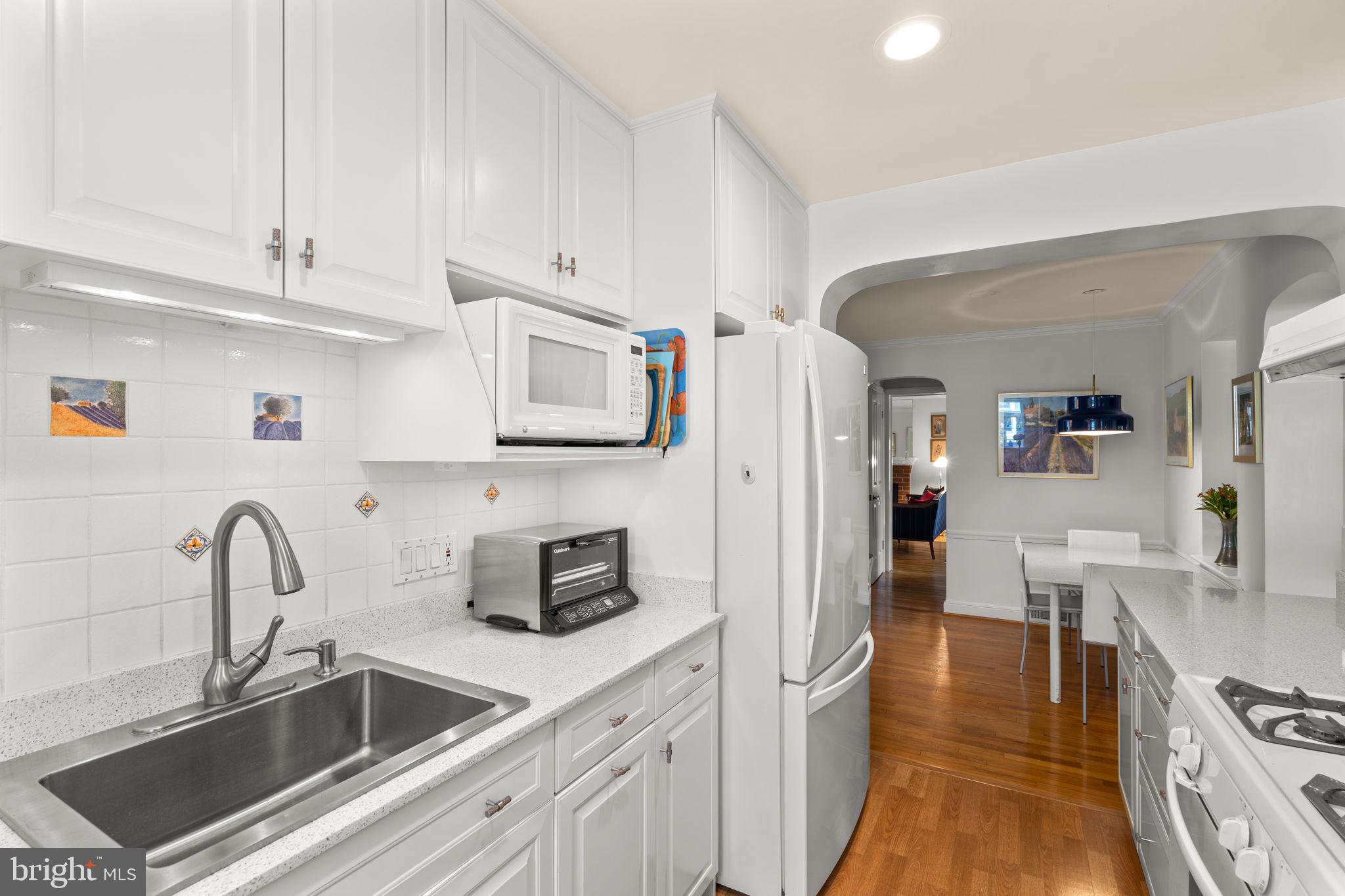 9508 Bruce Drive Silver Spring, MD 20901 - Photo 16 of 50 a kitchen with stainless steel appliances granite countertop a sink and a refrigerator