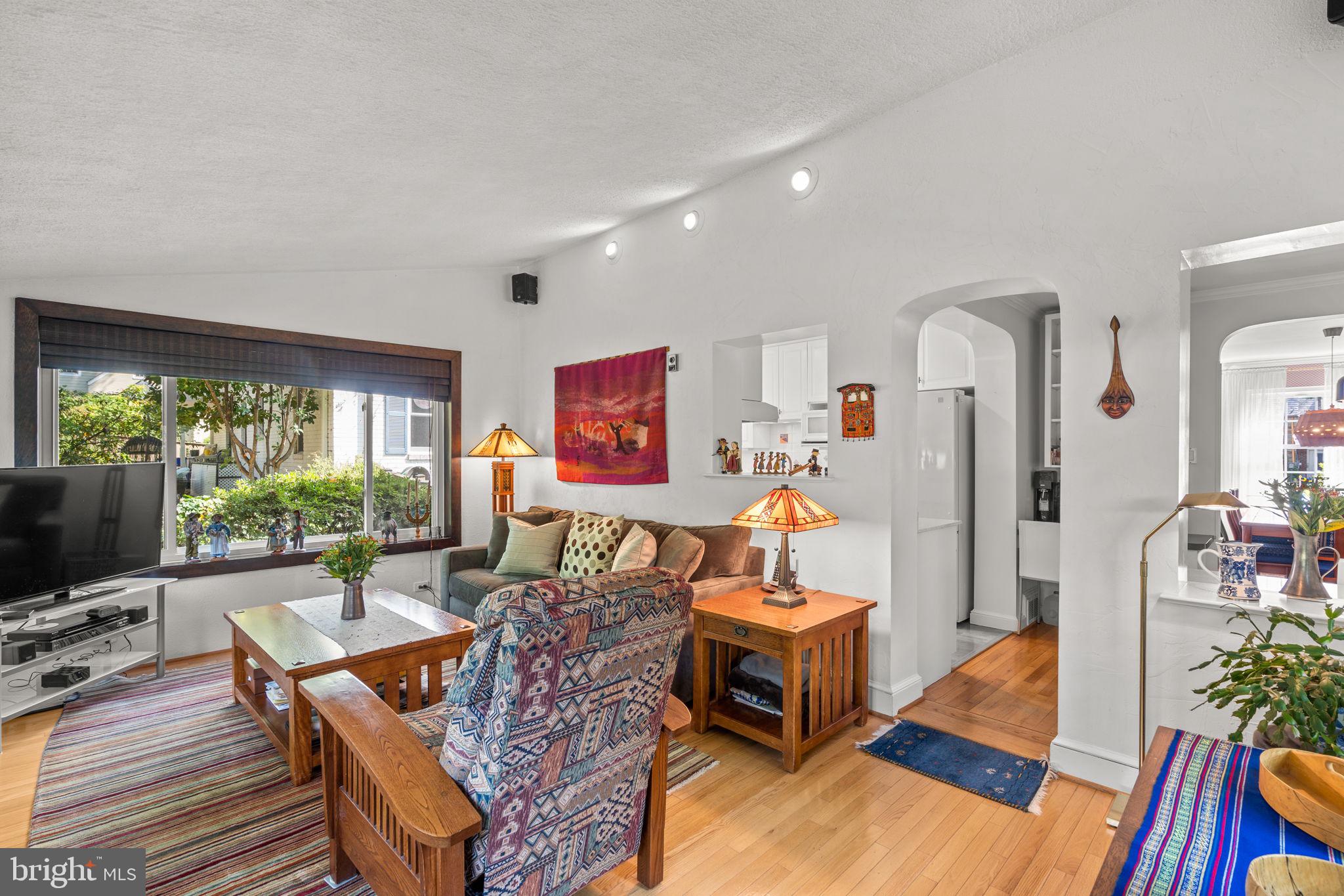 9508 Bruce Drive Silver Spring, MD 20901 - Photo 18 of 50 a living room with furniture a flat screen tv and a large window