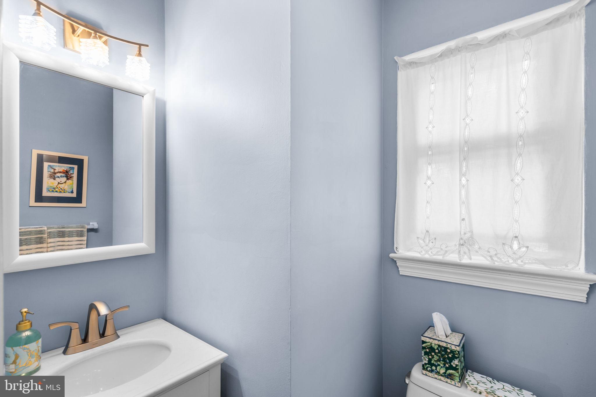 9508 Bruce Drive Silver Spring, MD 20901 - Photo 20 of 50 a bathroom with a sink and a mirror