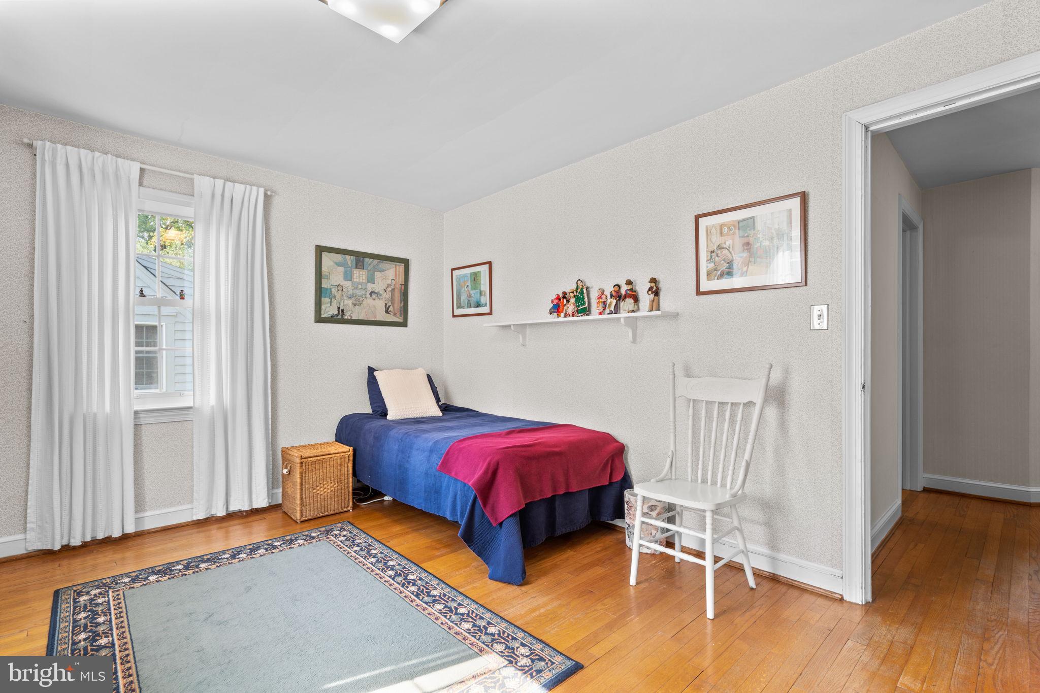 9508 Bruce Drive Silver Spring, MD 20901 - Photo 22 of 50 a bedroom with a bed and a table in it