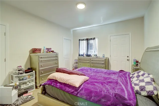 a bedroom with a bed and a closet