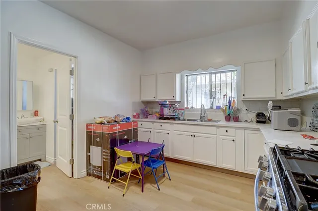 a kitchen with a sink stove and white cabinets