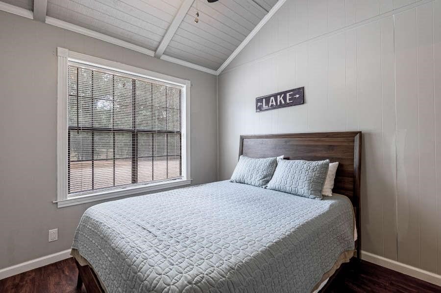 500 Lagoon Drive Point Blank, TX 77364 - Photo 19 of 23 a large bed sitting in a bedroom next to a window