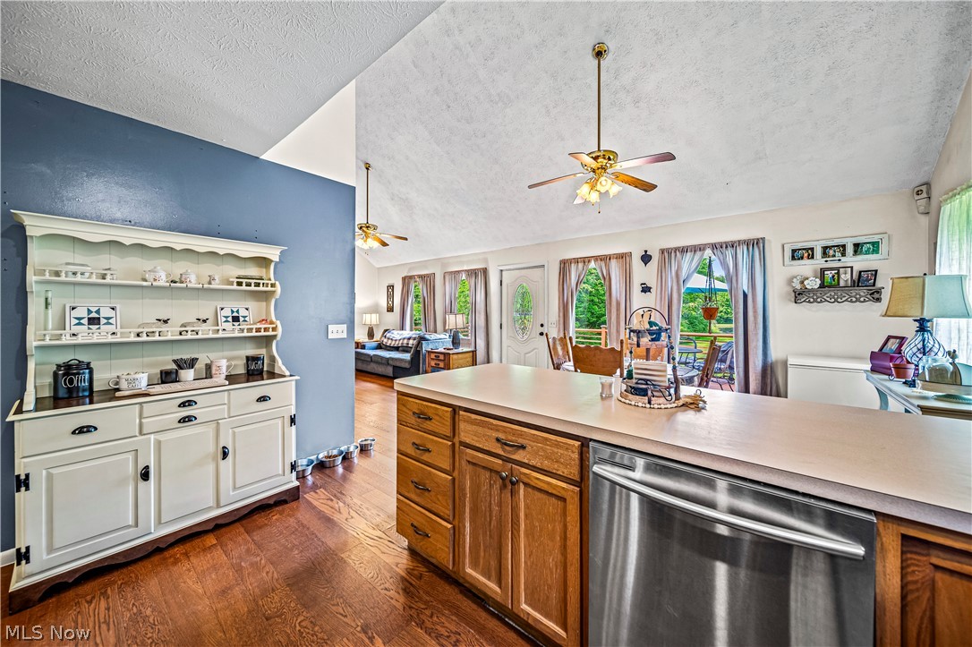 4460 Tower Road Dorset, OH 44032 - Photo 9 of 45 Kitchen featuring vaulted ceiling, ceiling fan, a textured ceiling, dishwasher, and dark hardwood / wood-style flooring