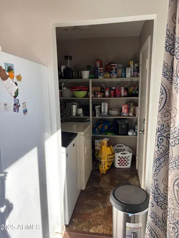 a kitchen with a refrigerator and a stove