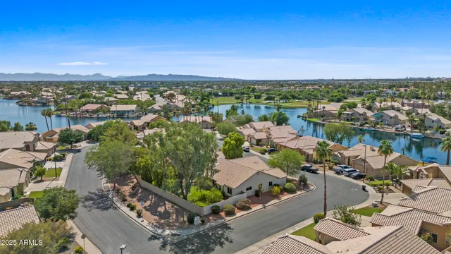 an aerial view of a city with lots of residential buildings ocean and mountain view in back