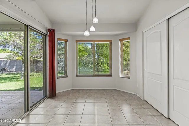 an aerial view of a house with a yard and lake view