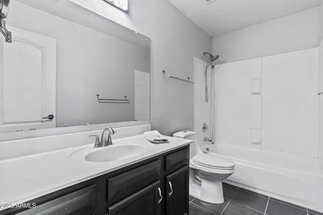 an empty room with chandelier fan