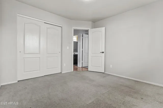 an empty room with closet area