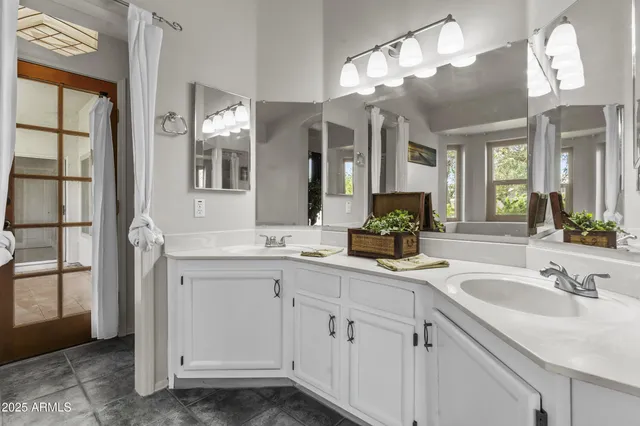 a bathroom with a sink double vanity and a mirror